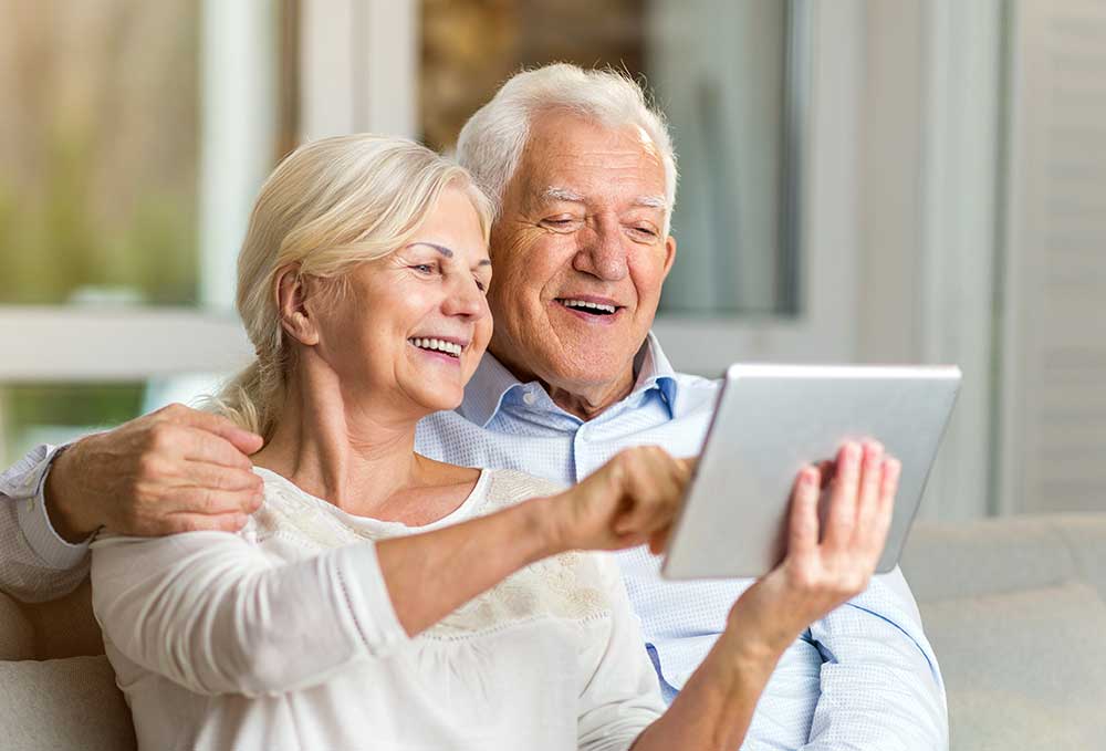 Seniors reading tablet